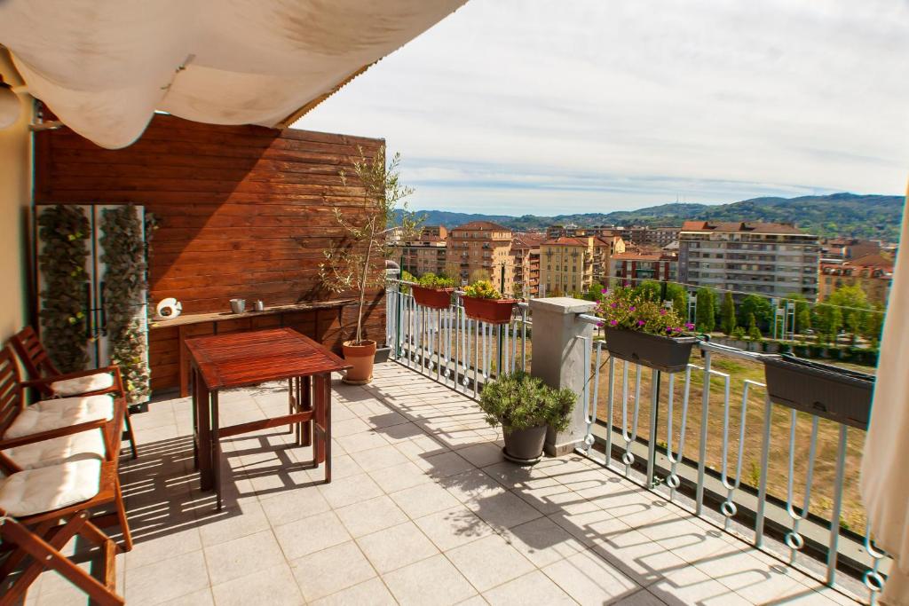 a balcony with a table and views of a city at Attico con Vista in Turin