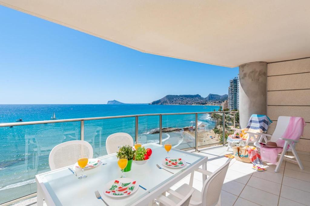 a dining room with a view of the ocean at Apartment Barlovento 2 - PlusHolidays in Calpe