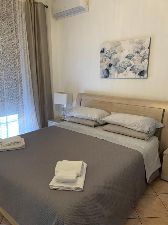 a bedroom with a bed with two towels on it at ARIA DI CASA in Verona