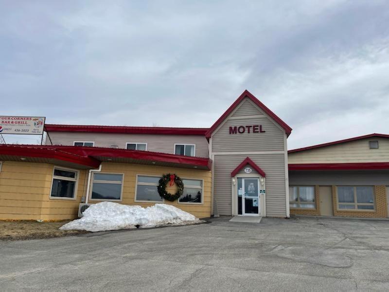 a motel sign on the side of a building at Gateway Motel USA in Madawaska