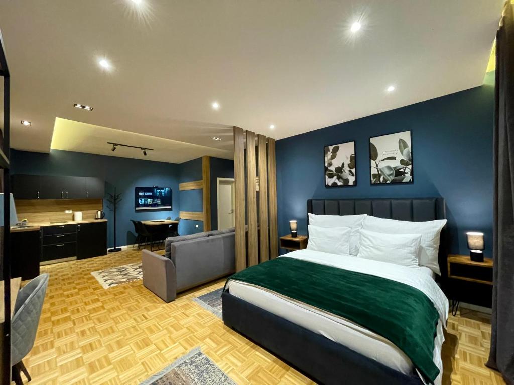 a bedroom with a large bed and a bathroom at Premium Apartments in Gjakove