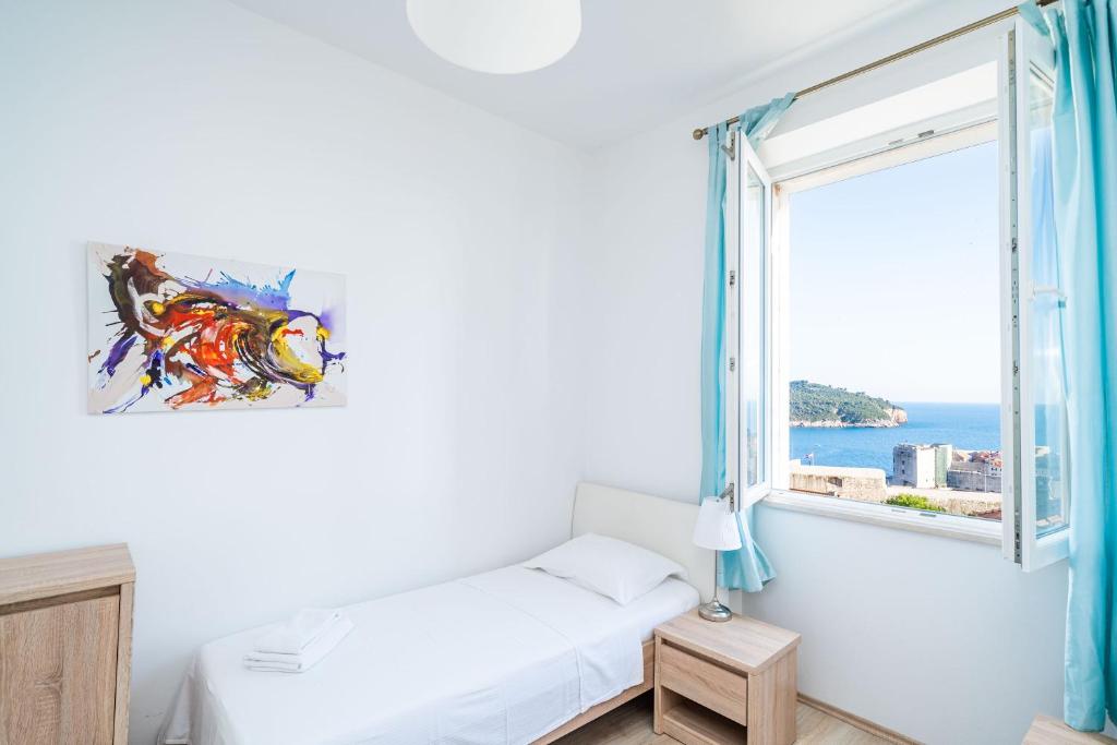 Posteľ alebo postele v izbe v ubytovaní Dubrovnik SEA VIEW MAGNOLIA APARTMENTS