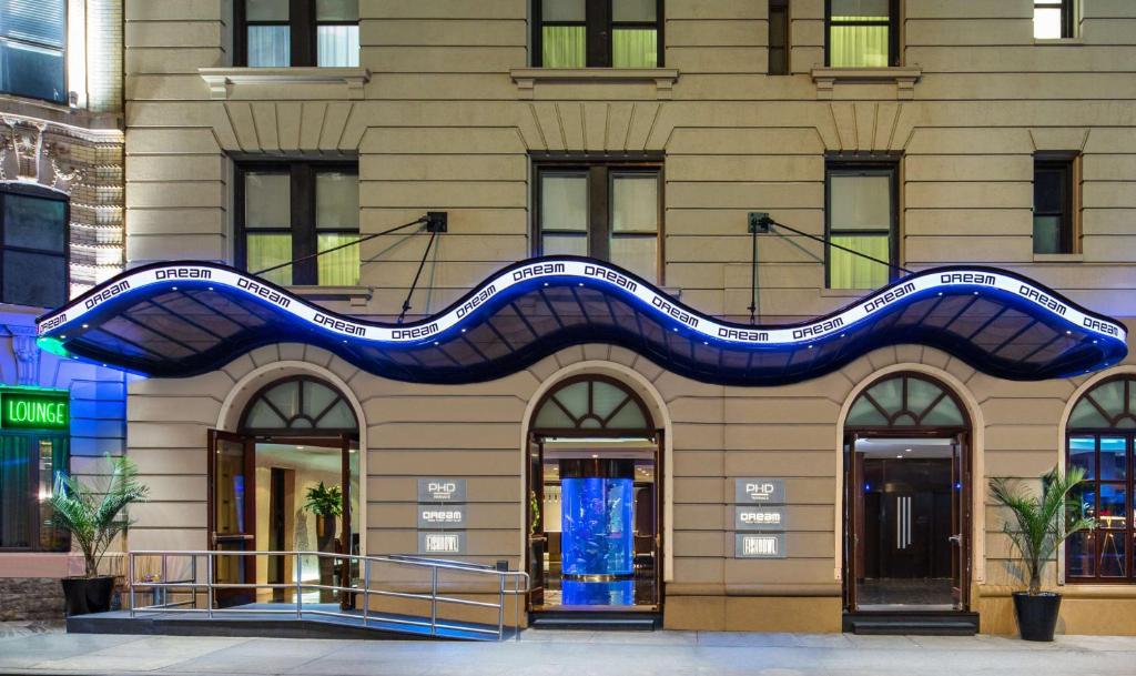 a building with a blue wave on it at Dream Midtown, by Hyatt in New York