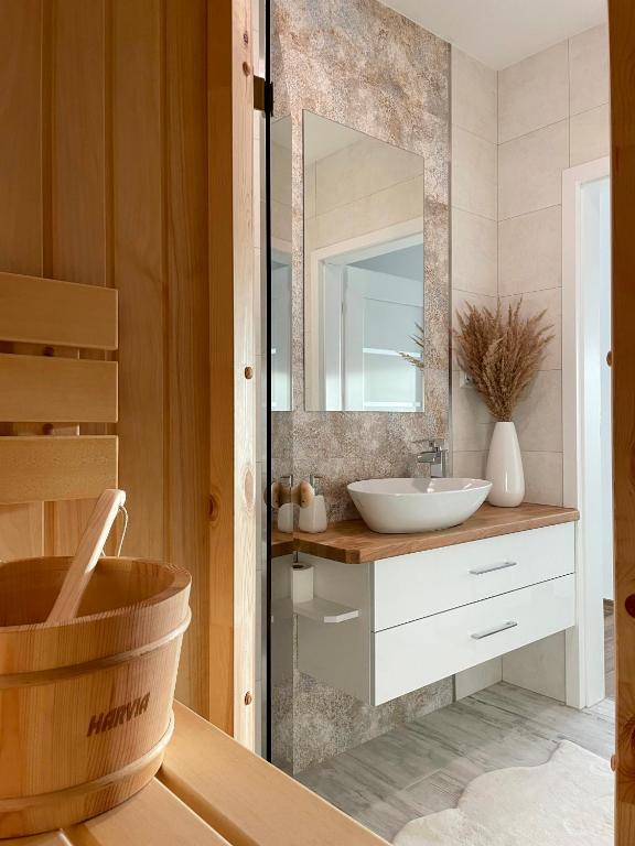 a bathroom with a sink and a mirror at Apartament Błękitne Spa in Ustrzyki Dolne