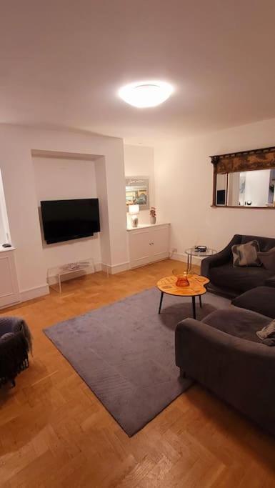 a living room with a couch and a table at Spacious 2 bedroom flat in Baker street in London