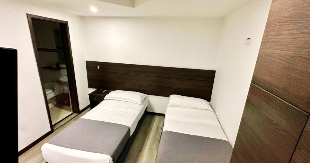 Postel nebo postele na pokoji v ubytování Hotel Expo Hotel Ferial