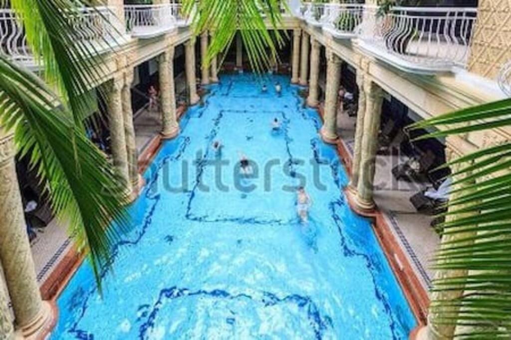 a swimming pool with people in it with palm trees at ALWAYS A HUGE SALE! in Budapest