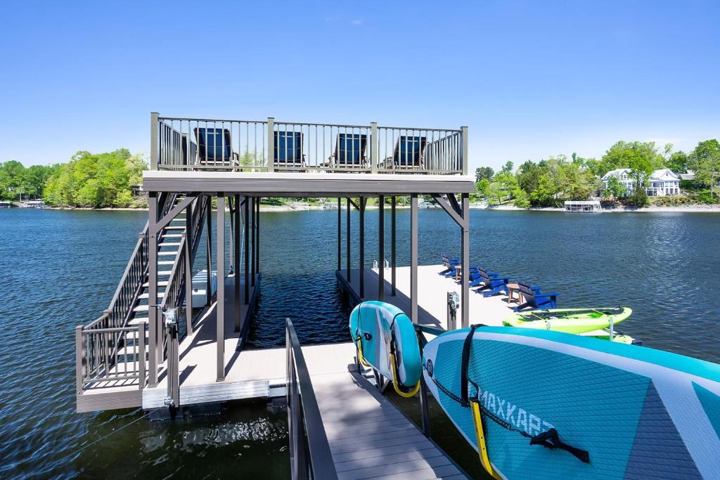 a dock with two boats on the water at New Home, Dock, Home Theatre Projector, Hot Tub, Fire Pit, Kayaks in Winchester