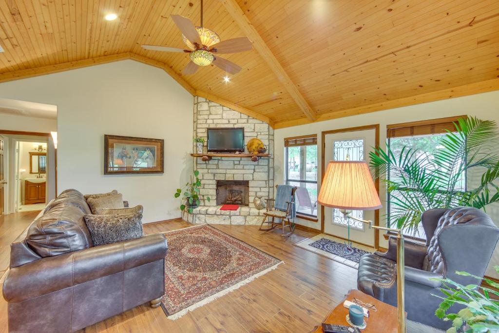 a living room with a couch and a fireplace at Wills Point Vacation Rental on 10 Acres of Land! in Canton