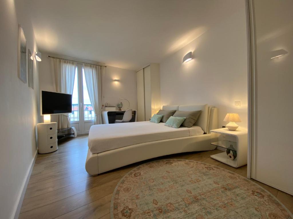 1 dormitorio con 1 cama blanca grande y 1 alfombra en Au cœur de la Vieille Ville, en Ajaccio