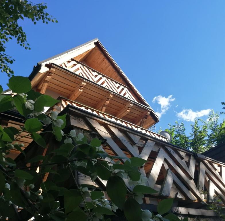 ein Gebäude mit einem Holzdach mit dem Himmel im Hintergrund in der Unterkunft Willa Mitia in Zakopane
