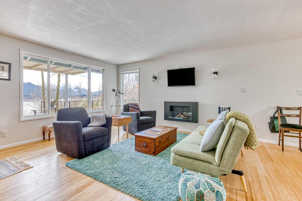 a living room with a couch and chairs and a tv at Gorge View in Stevenson