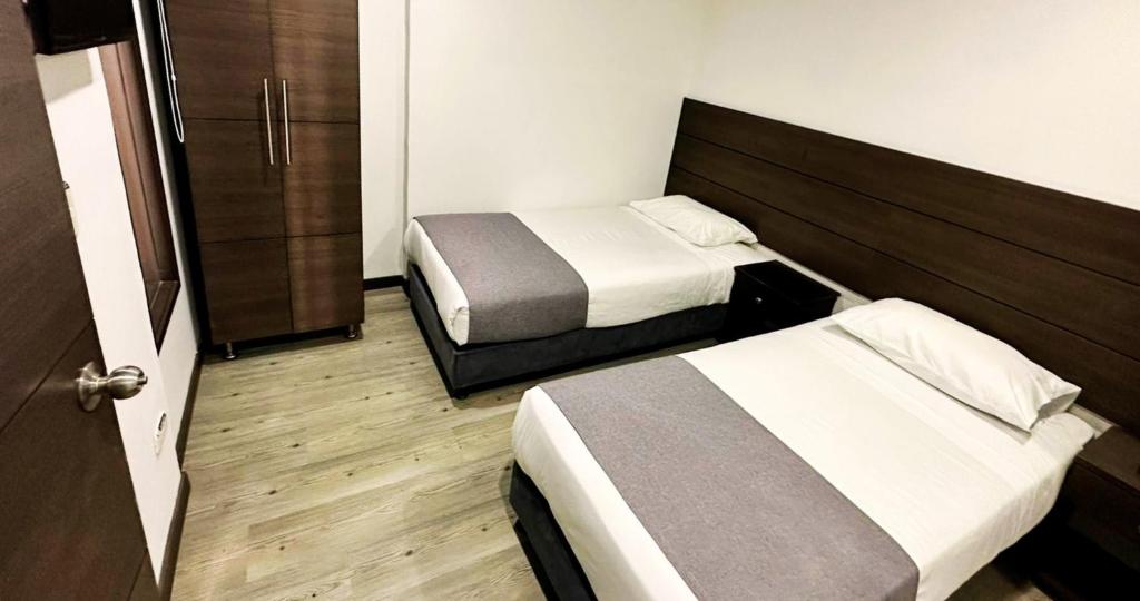 Postel nebo postele na pokoji v ubytování Hotel Expo Hotel Ferial