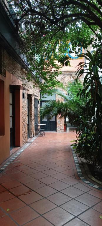 a courtyard of a building with trees and a sidewalk at Pasaje Solar in Buenos Aires