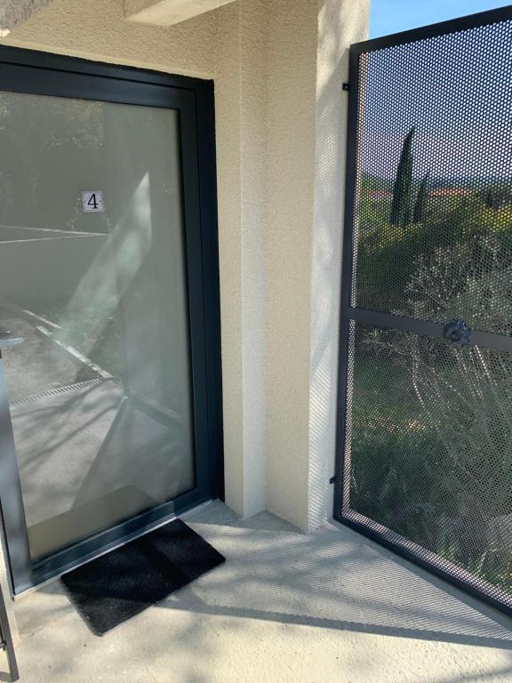 a large screen door to a patio with a window at T1 bis rénové au centre d’Auch in Auch