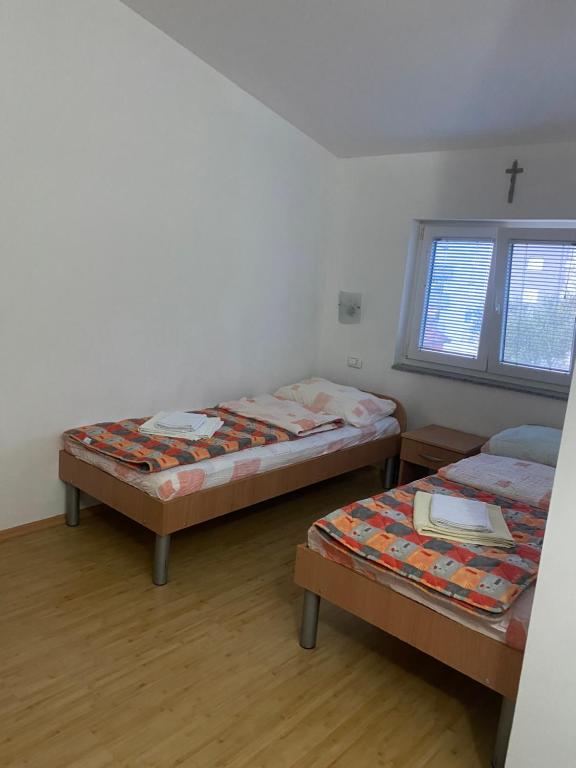 a room with two beds and a window at Maća i Ante Pavlović in Međugorje