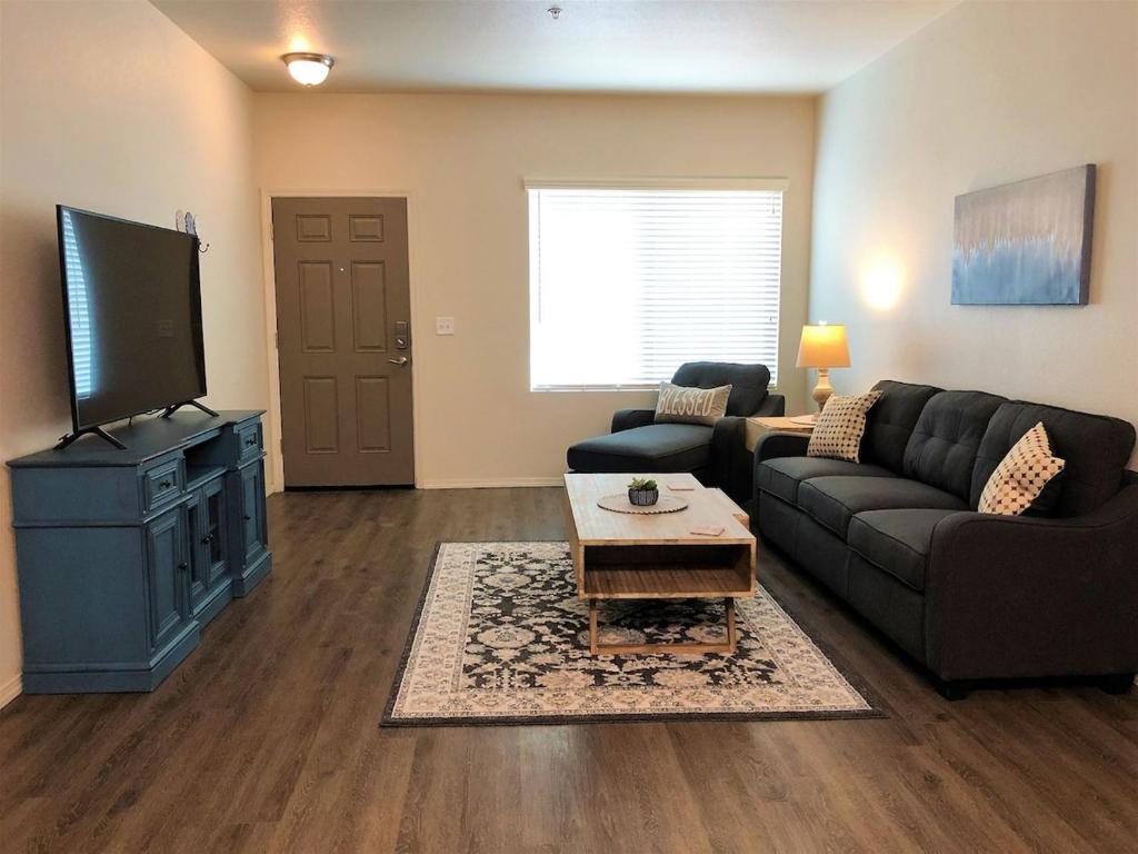 a living room with a couch and a flat screen tv at Granite Apartment - Prescott Cabin Rentals in Prescott