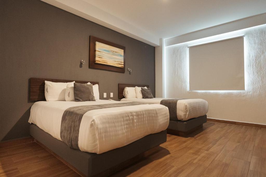 Postel nebo postele na pokoji v ubytování Hoteles Unico Express