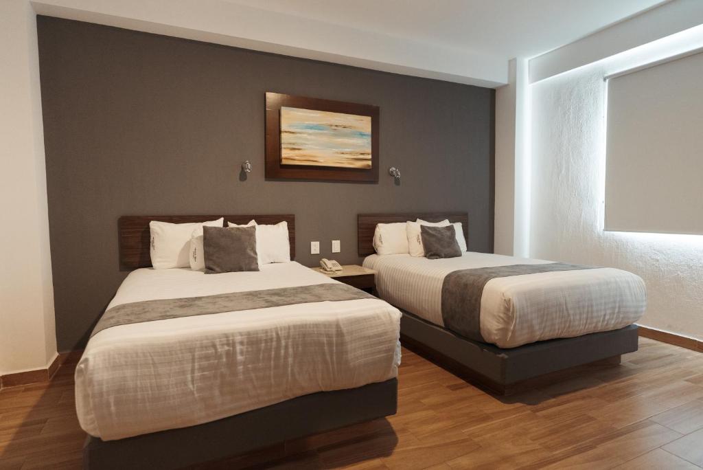 Postel nebo postele na pokoji v ubytování Hoteles Unico Express