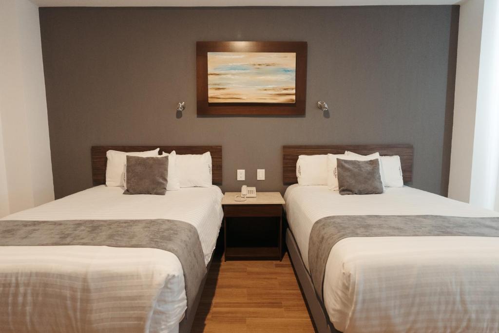Postel nebo postele na pokoji v ubytování Hoteles Unico Express