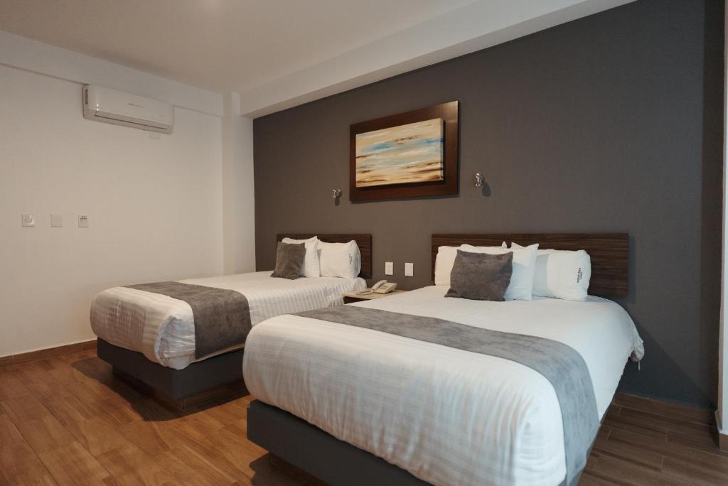 Postel nebo postele na pokoji v ubytování Hoteles Unico Express