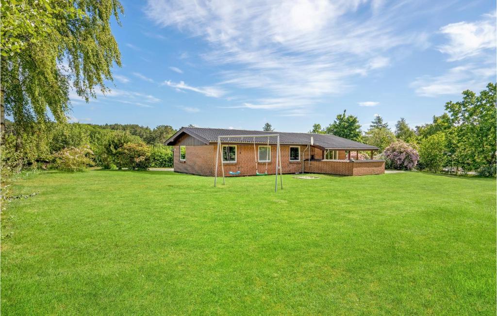 una casa in un grande cortile con erba verde di Holiday Home Hvidkløvervej Ebeltoft a Ebeltoft