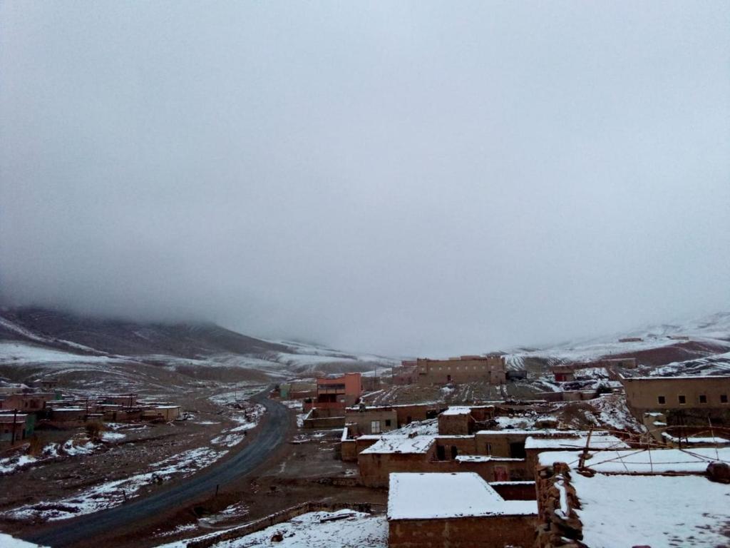 a town in the snow with a road and buildings at Ait daoud ait hani tinghir 