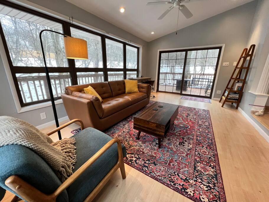 a living room with a couch and a table at Spacious Cabin with Private Covered Hot Tub in Albrightsville