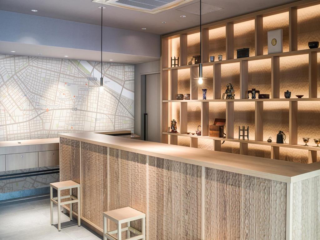 a rendering of a store with a counter and two stools at Vessel Inn Asakusa Tsukuba Express in Tokyo