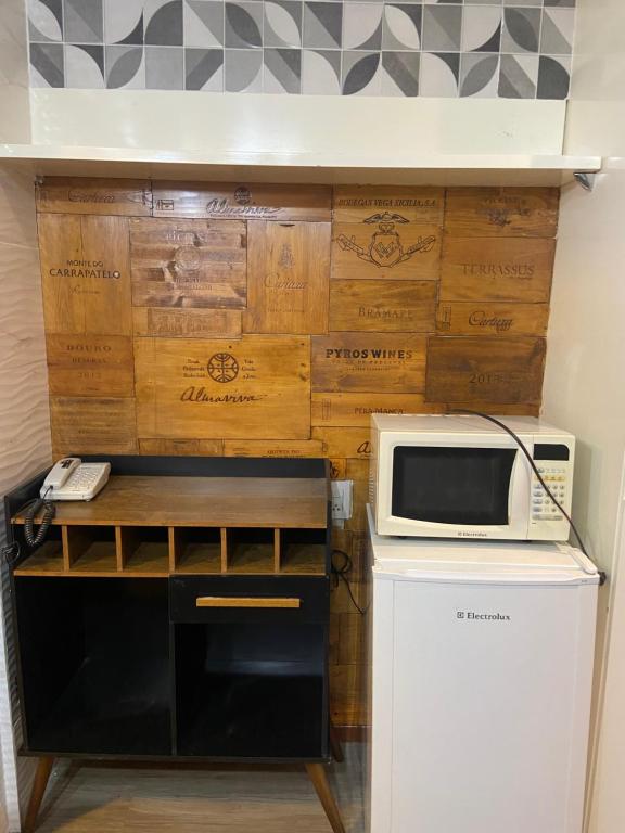 a microwave oven sitting on top of a refrigerator at Hotel Taguatinga Flat - conforto e requinte - Apto 416 in Brasilia