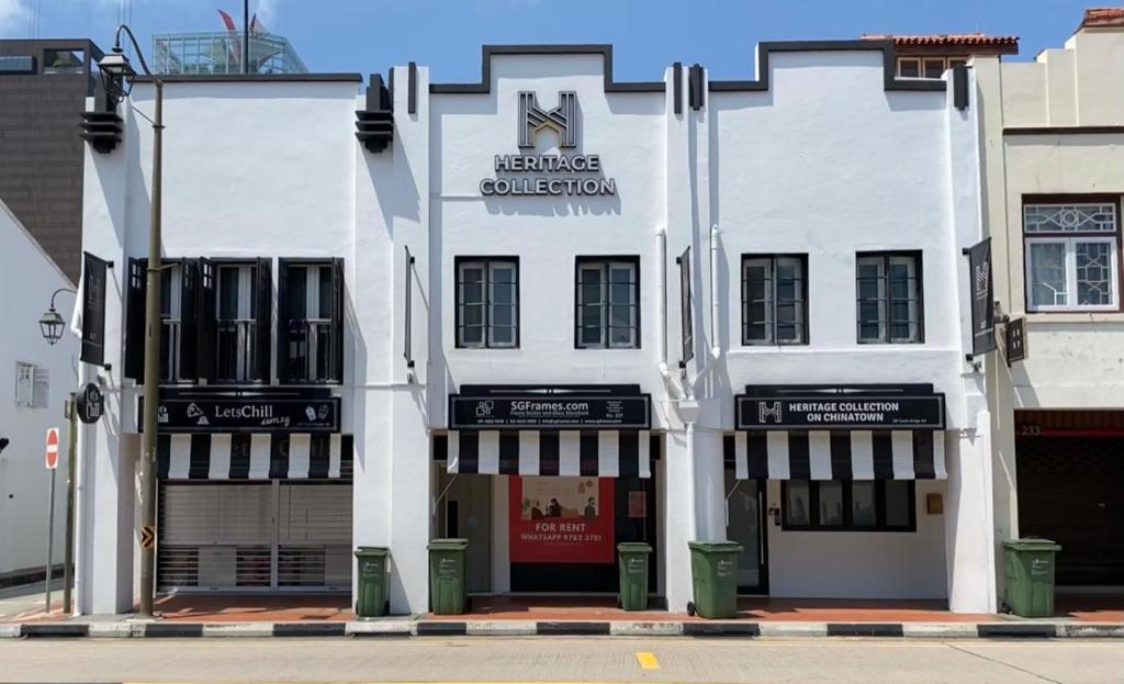 a white building with a sign on the front of it at Heritage Collection on Chinatown - A Digital Hotel in Singapore