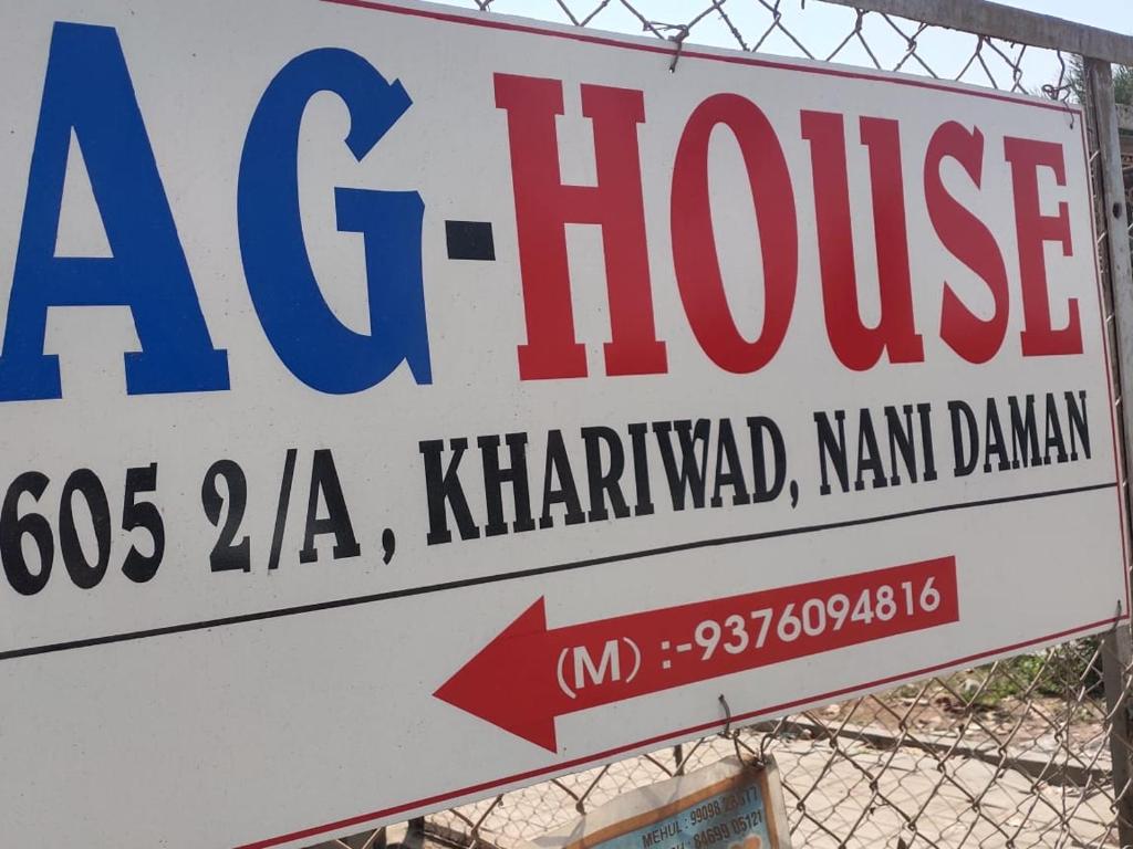 a sign for aac house on a fence at AG House Daman holiday Home apartment in Daman