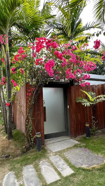 a building with pink flowers in front of a door at Fu Wan Cafe Villa in Donggang