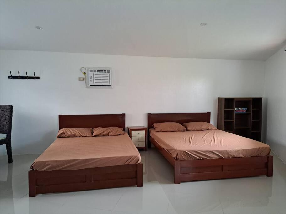 two beds sitting next to each other in a bedroom at Seaview Hill (Family room with private Pool) 