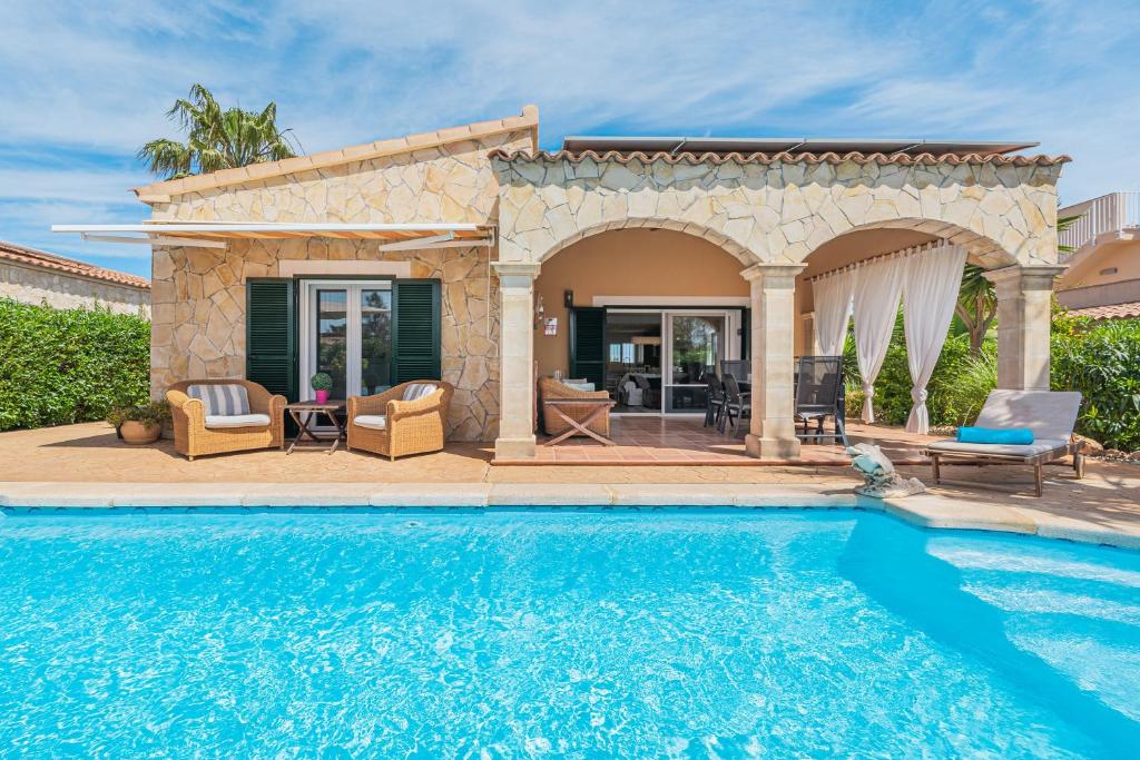 a villa with a swimming pool and a patio at Casa Mayor Strand Es Trenc 5 min in Sa Ràpita