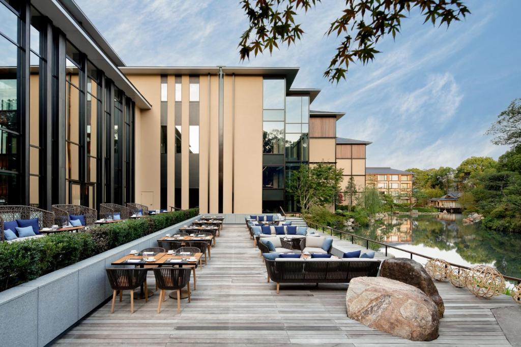 an outdoor patio with couches and tables and a building at Four Seasons Hotel Kyoto in Kyoto