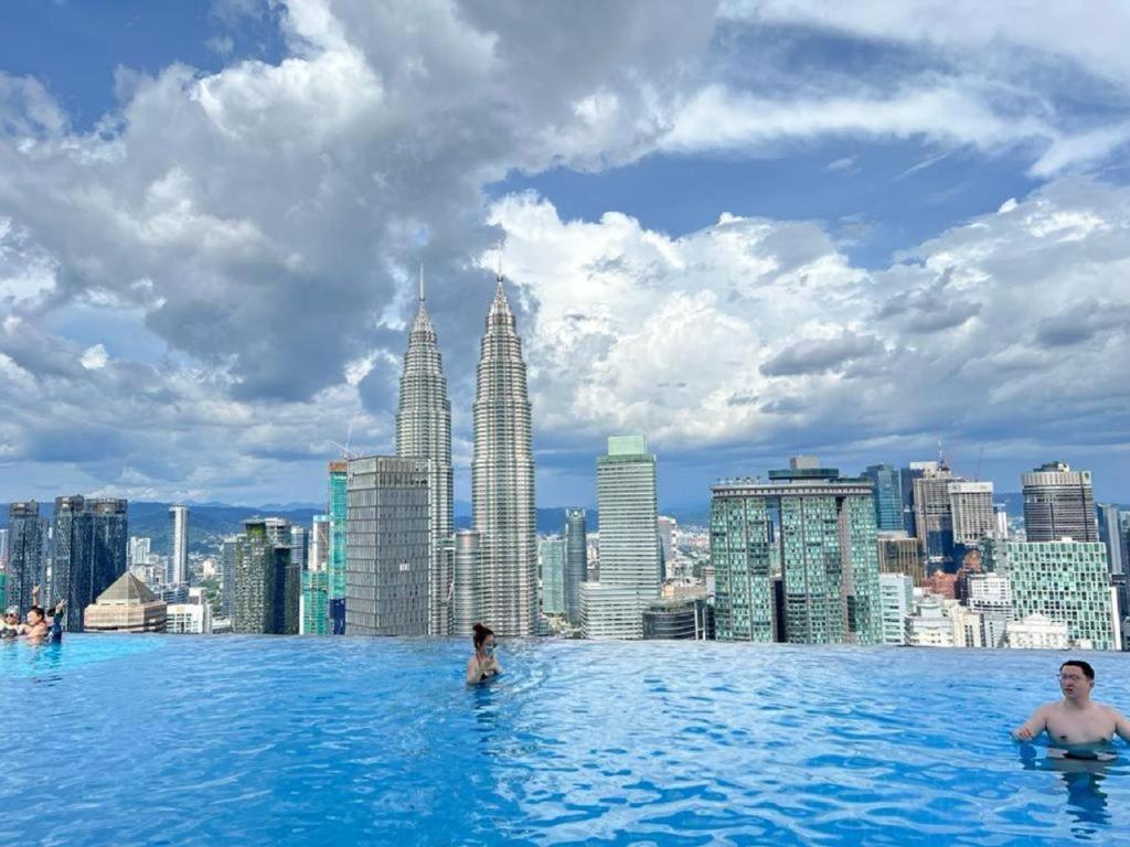 a infinity pool with a view of a city at ASTRA @ Suite Platinum 2 KLCC in Kuala Lumpur