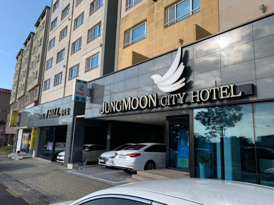 a luxury hotel with a car parked in front of it at SH Jungmoon City Stay in Seogwipo