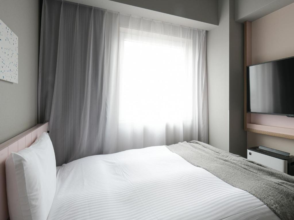 Postel nebo postele na pokoji v ubytování Vessel Inn Takadanobaba Station