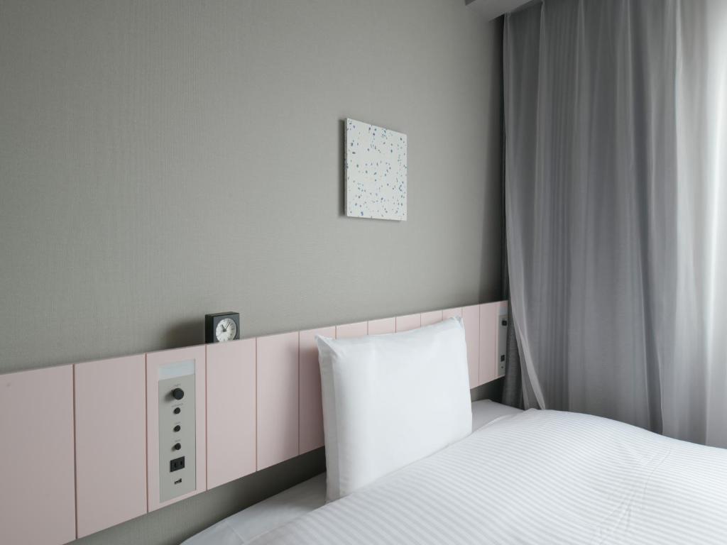 Postel nebo postele na pokoji v ubytování Vessel Inn Takadanobaba Station