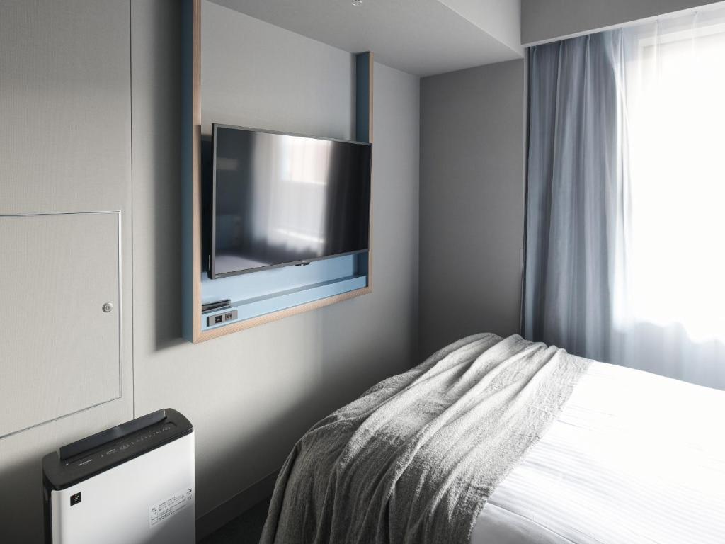 TV a/nebo společenská místnost v ubytování Vessel Inn Takadanobaba Station