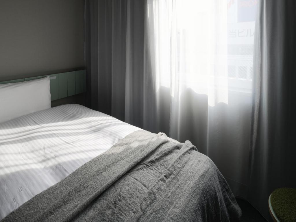 Postel nebo postele na pokoji v ubytování Vessel Inn Takadanobaba Station