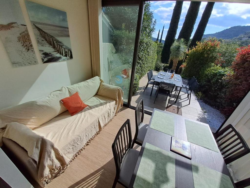 a living room with a couch and a table at T3 Le Bagnolet Les Mas de Pramousquier in Le Lavandou