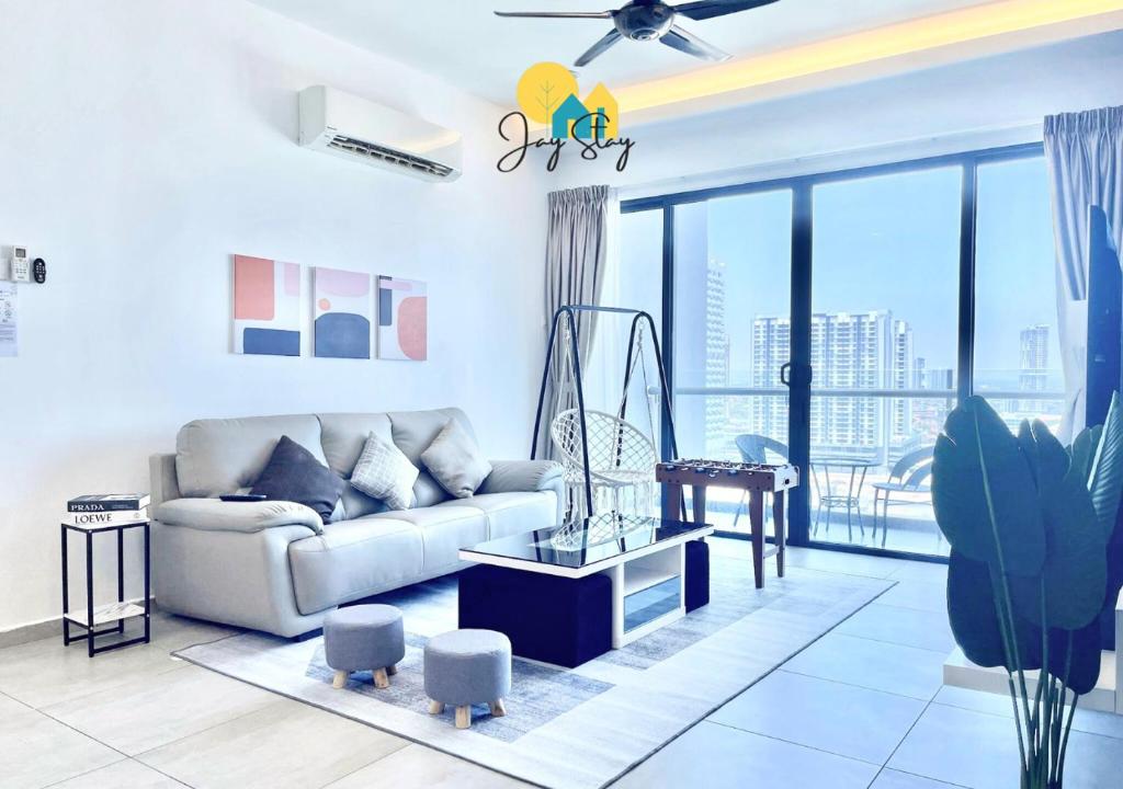 a living room with a couch and a large window at NEW! Atlantis Residence I D1607 Premium 2BR I 5-10pax I Swing I JonkerSt I City Centre by Jay Stay in Melaka