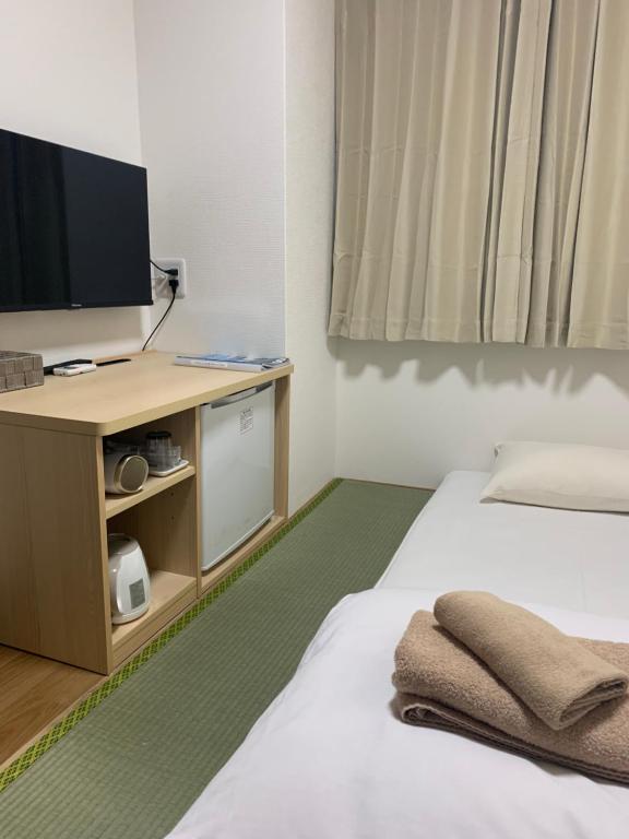Postel nebo postele na pokoji v ubytování Hotel Shin-Imamiya