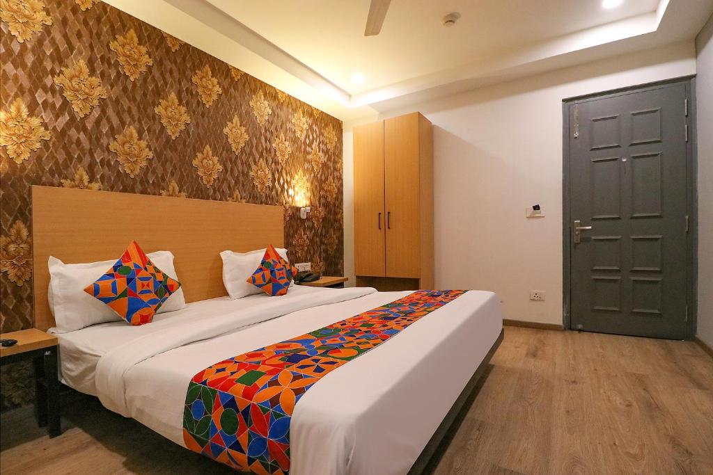 a bedroom with a large bed in a room at FabExpress La Serene - Near Yamuna Sports Complex in New Delhi