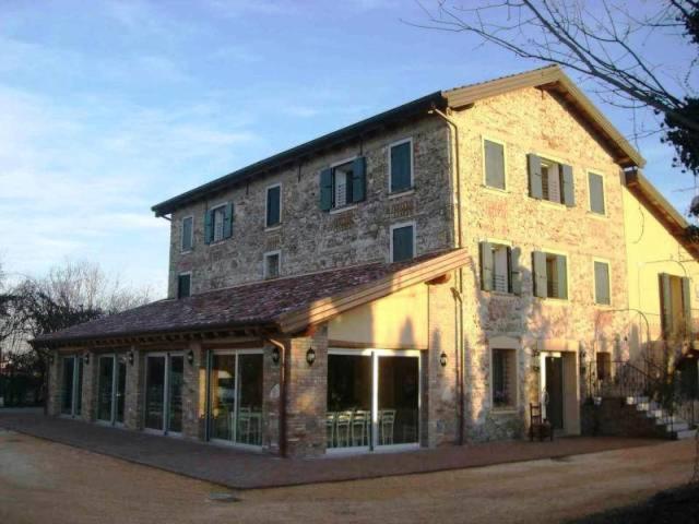 a large brick building with windows on a street at Agriturismo Antiche Mura in Jesolo