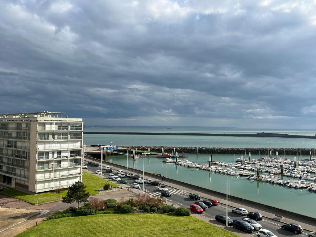 a view of a marina and a parking lot with cars at Vivez la Marina - Plage - Port de plaisance in Le Havre