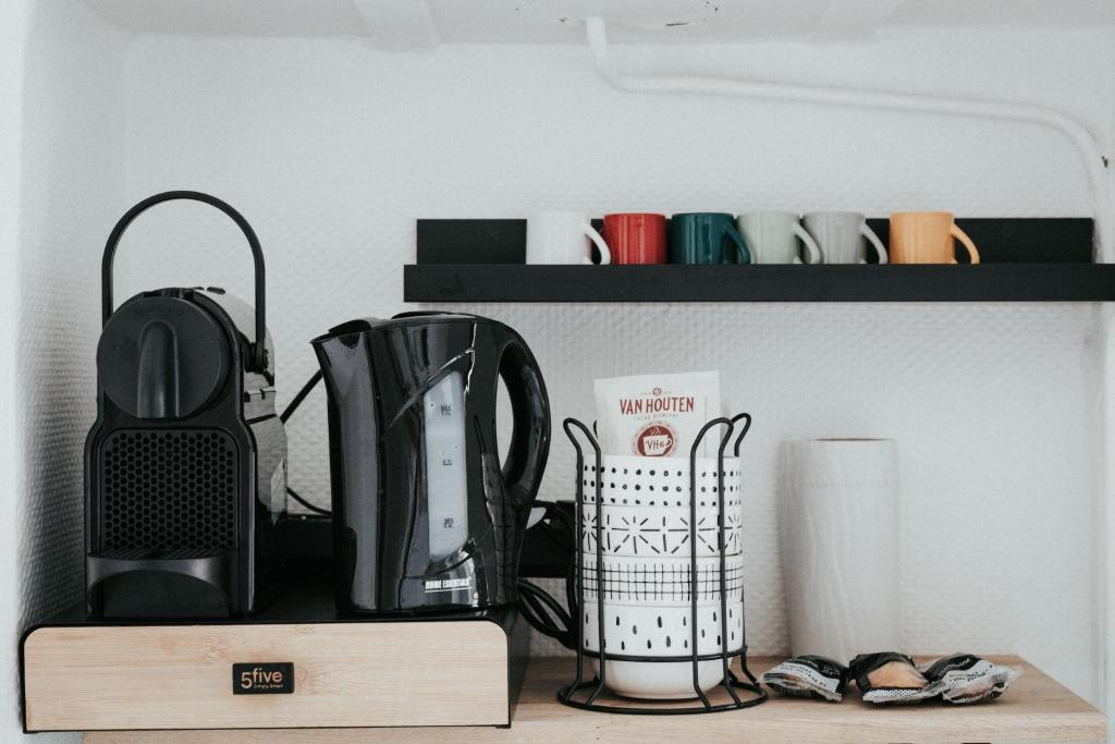 a shelf with various kitchen utensils on it at F3 Av république avec garage (c) in Clermont-Ferrand