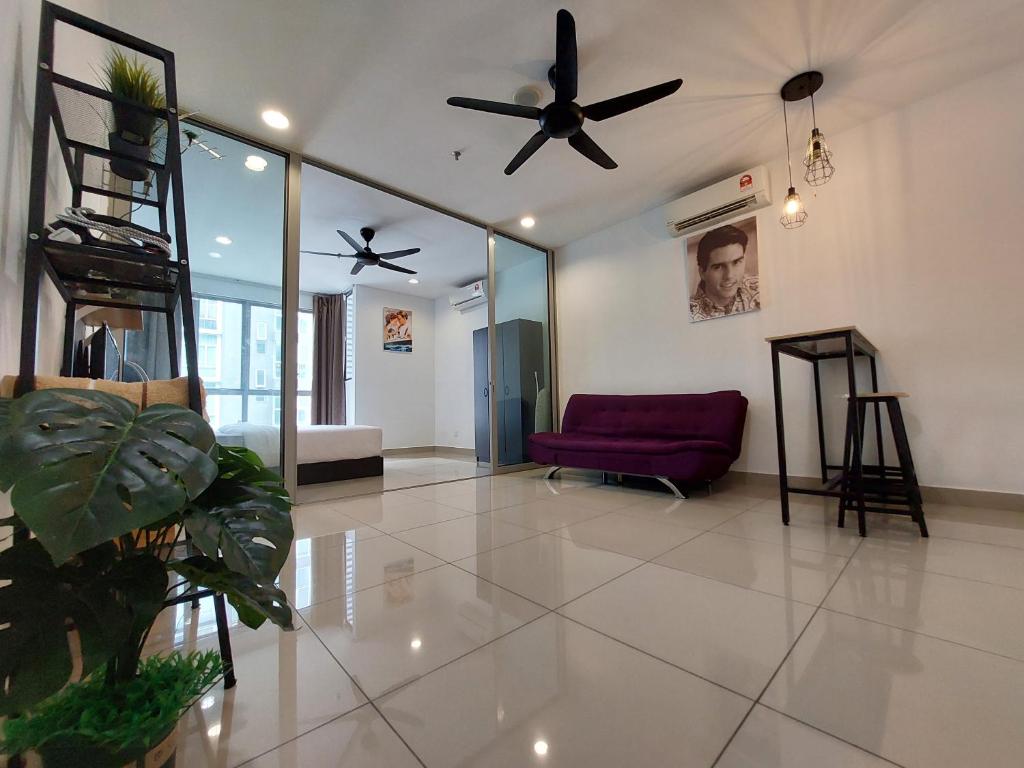 a living room with a ceiling fan and a couch at 3 Elements-MRT2 -30min to TRX Bkt Bintang -Wifi - Self Check In in Seri Kembangan